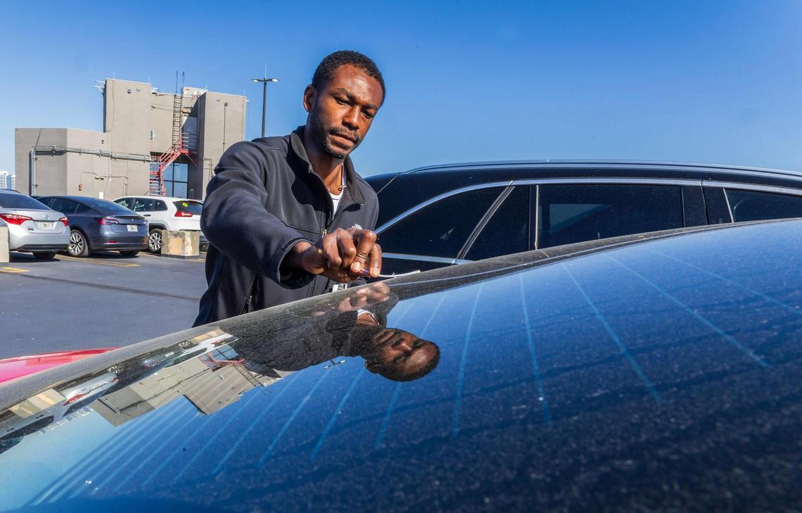 Research Assistant Carlos Wright collects pollen samples from a car’s shield for Naresh Kumar, a professor of environmental health at the University of Miami Miller School of Medicine at the University of Miami Medical Campus in Miami, Florida, on Tuesday March 18, 2025.