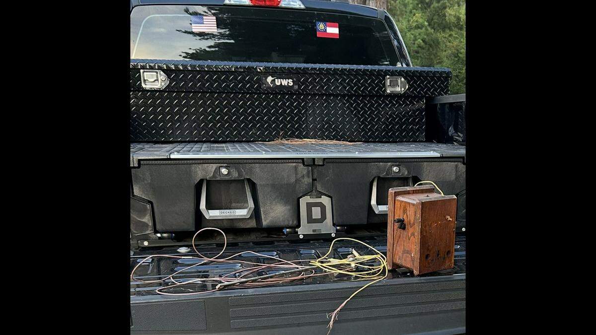 Sgt. Matt Garthright with the Georgia DNR Law Enforcement Division retrieved this old crank phone from a creek, officials say. 