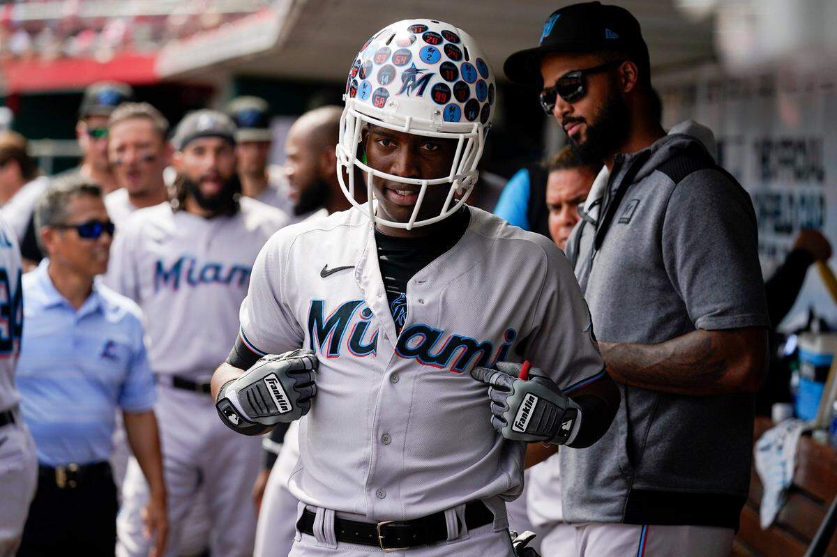 Miami Marlins’ Jesus Sanchez, center, celebrates with teammates after hitting a solo home run during the ninth inning of a baseball game against the Cincinnati Reds Thursday, July 28, 2022, in Cincinnati. (AP Photo/Jeff Dean)