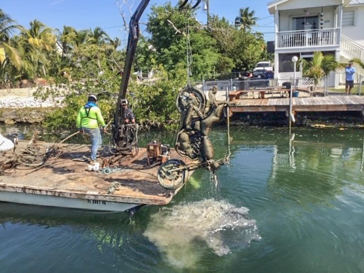 A motorcycle is removed from canal. no. 307 on Upper Sugarloaf Key.