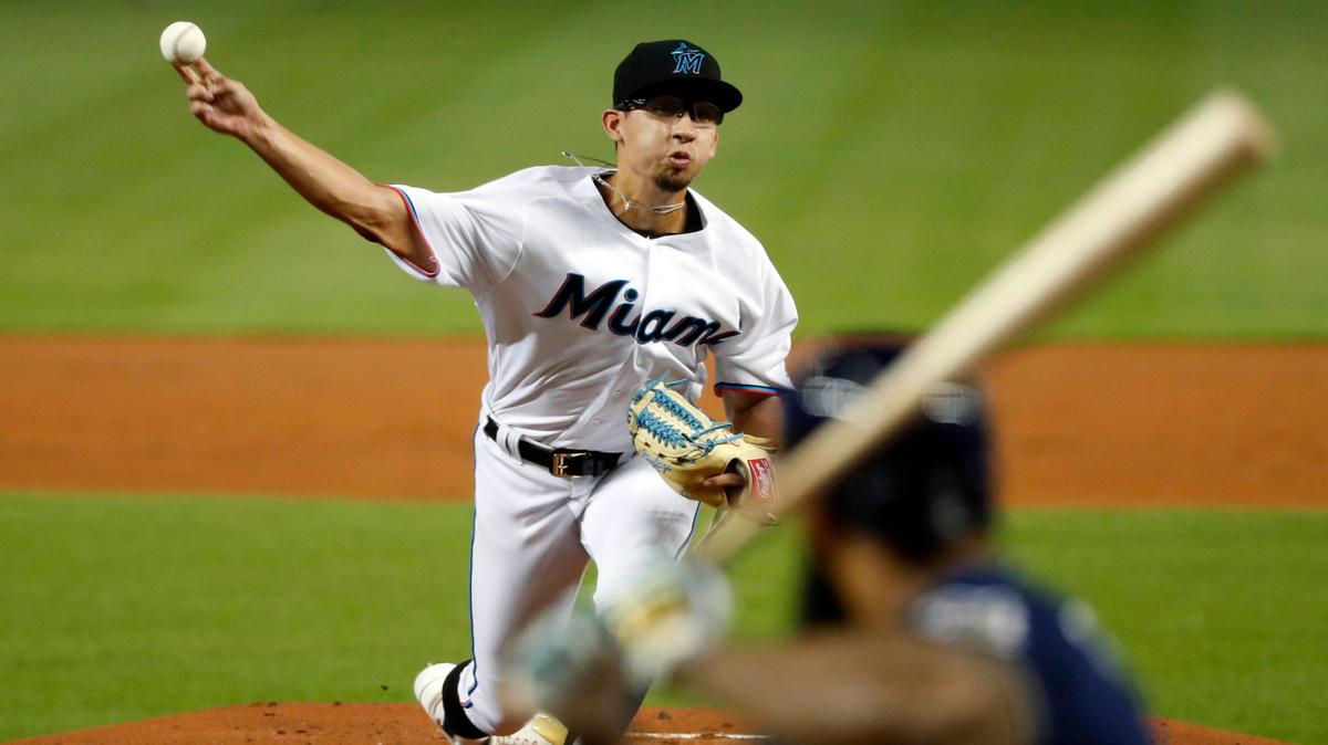Miami Marlins’ Robert Dugger, top, pitches to Milwaukee Brewers’ Eric Thames during the first inning of a baseball game, Monday, Sept. 9, 2019, in Miami. (AP Photo/Wilfredo Lee)