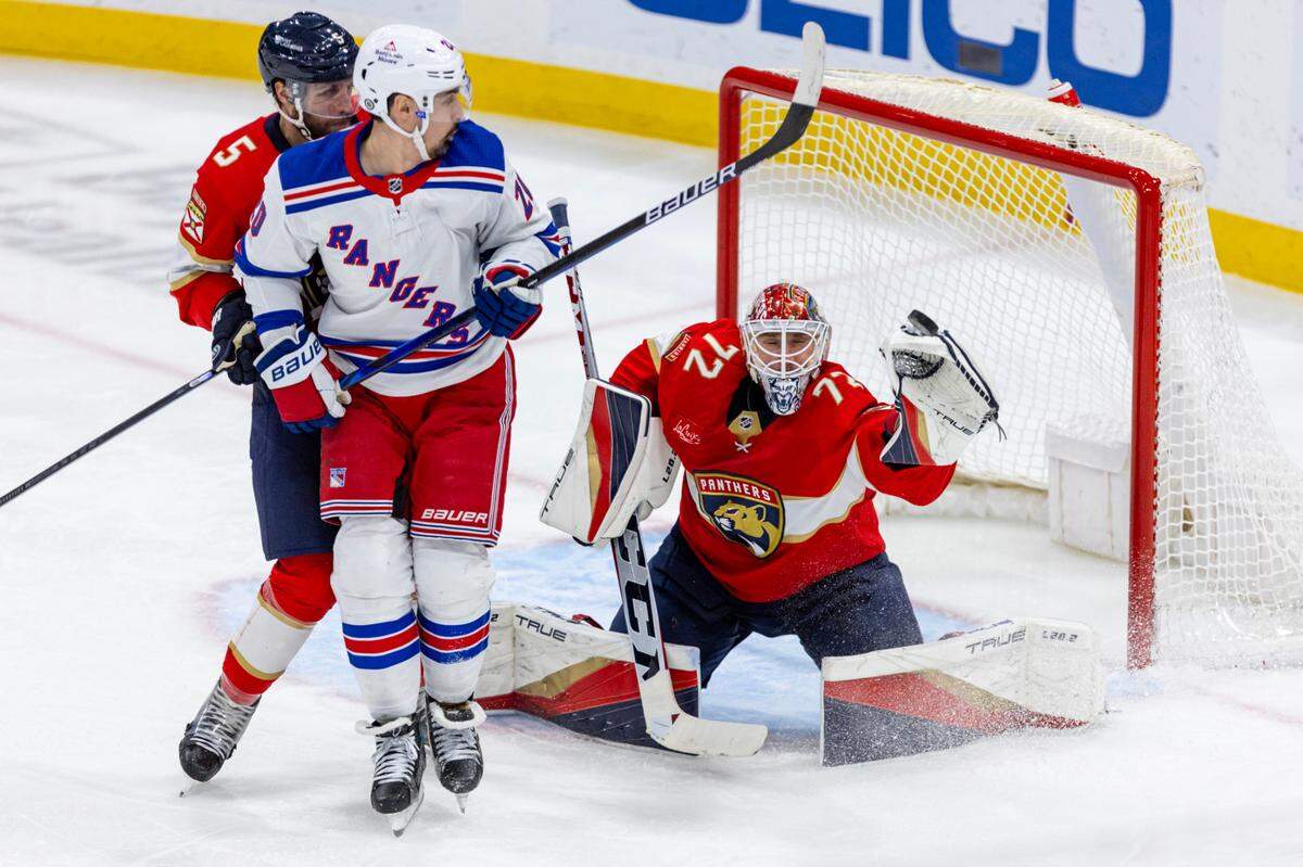 Florida Panthers goalie Sergei Bobrovsky (13) saves a shot by a New York Rangers player during the third period of an NHL game at Amerant Bank Arena in Sunrise, Florida, on Friday, December 29, 2023.