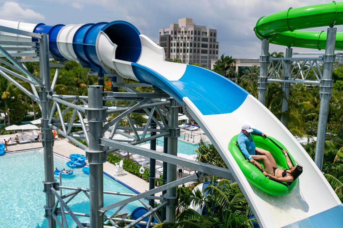 Guests ride down a waterslide at Tidal Cove Waterpark in Aventura’s JW Marriott Miami Turnberry Resort & Spa.
