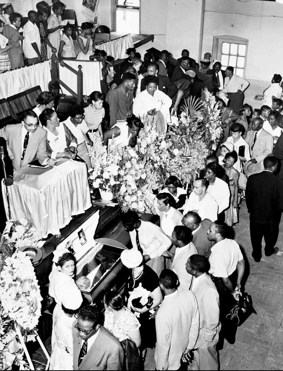 Mourners pass the casket of 14-year-old Emmett Till during funeral services at Roberts Temple Church of God in Christ on Sept. 6, 1955, in Chicago.