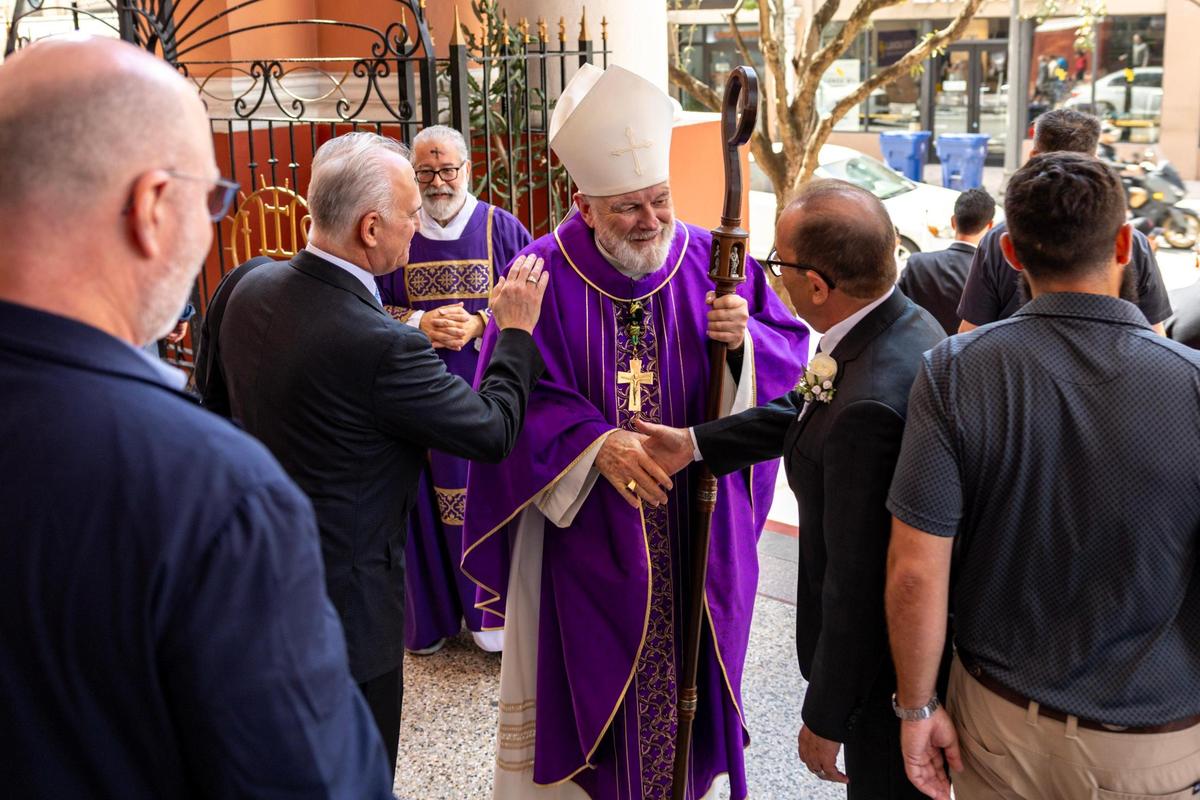 Archbishop Thomas Wenski meets with congregants following Ash Wednesday mass.