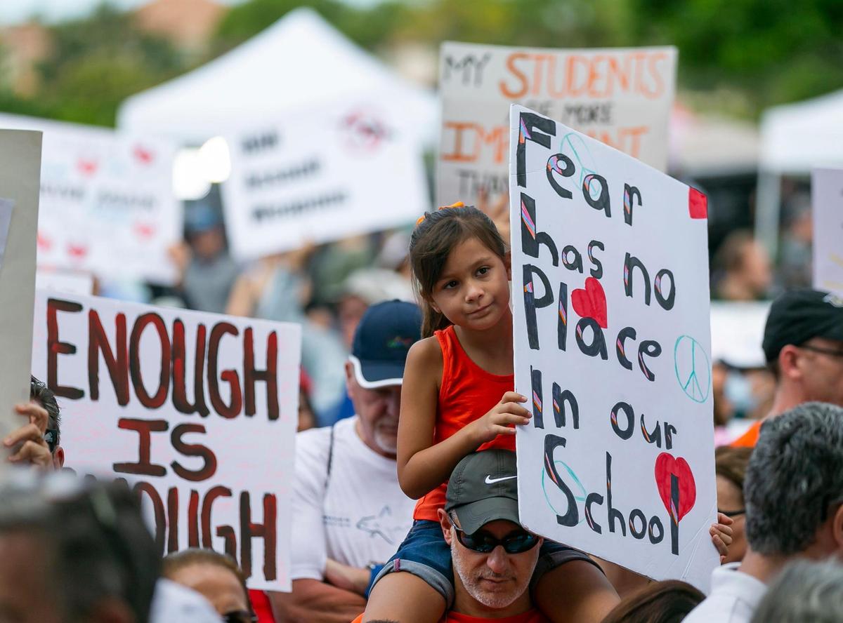 Lia Perez and her dad, Dan Perez, from Boca Raton, participate in the March For Our Lives rally at Pine Trails Park on Saturday, June 11, 2022 in Parkland, Fla. One of the main goals of the rally is to increase pressure on politicians to pass laws that help prevent gun violence.