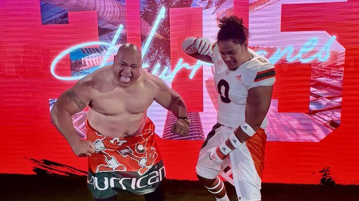 Five-star Bradenton IMG Academy tackle Francis Mauigoa (right) poses for a photo with defensive line coach Joe Salave’a, a fellow native of American Samoa, while on an official visit with the Miami Hurricanes in June of 2023.