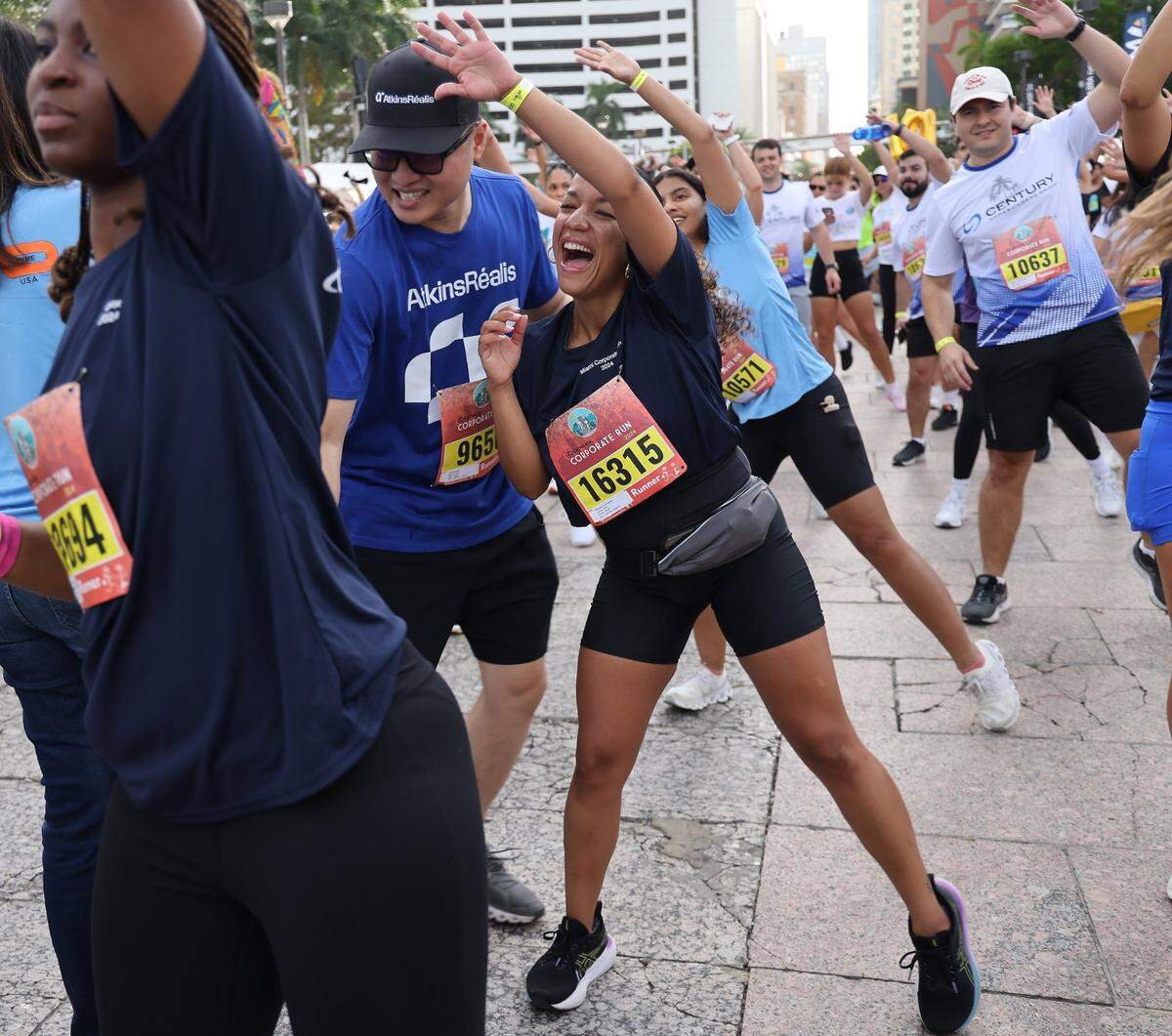 Runners perform exercises as they warm up before the start of the race at Bayfront Park.