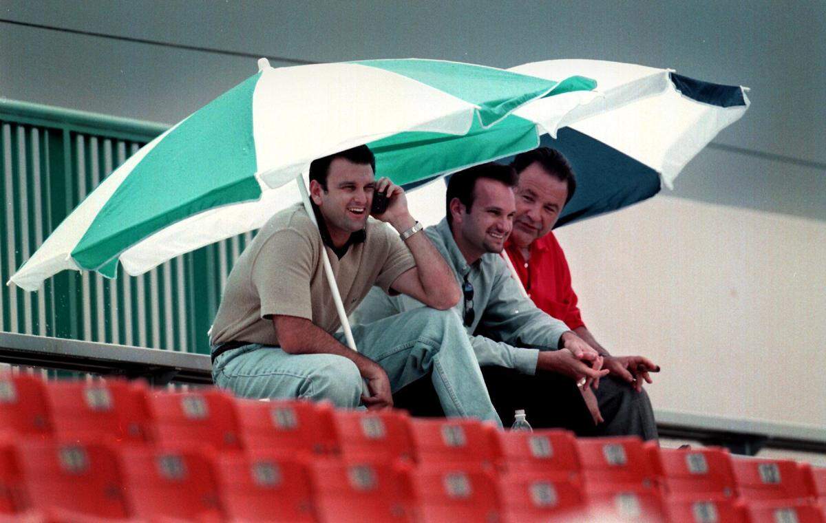Agent Drew Rosenhaus watches a Dolphins practice.