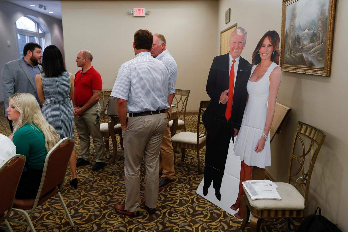 A cutout of President Donald Trump and his wife, Melania, are shown in the lobby during a training session for Women for Trump, An Evening to Empower, in Troy, Michigan, on Thursday. Female surrogates and supporters fanned out across important battlegrounds in a high-profile push to make the president’s case on the economy and to train campaign volunteers.
