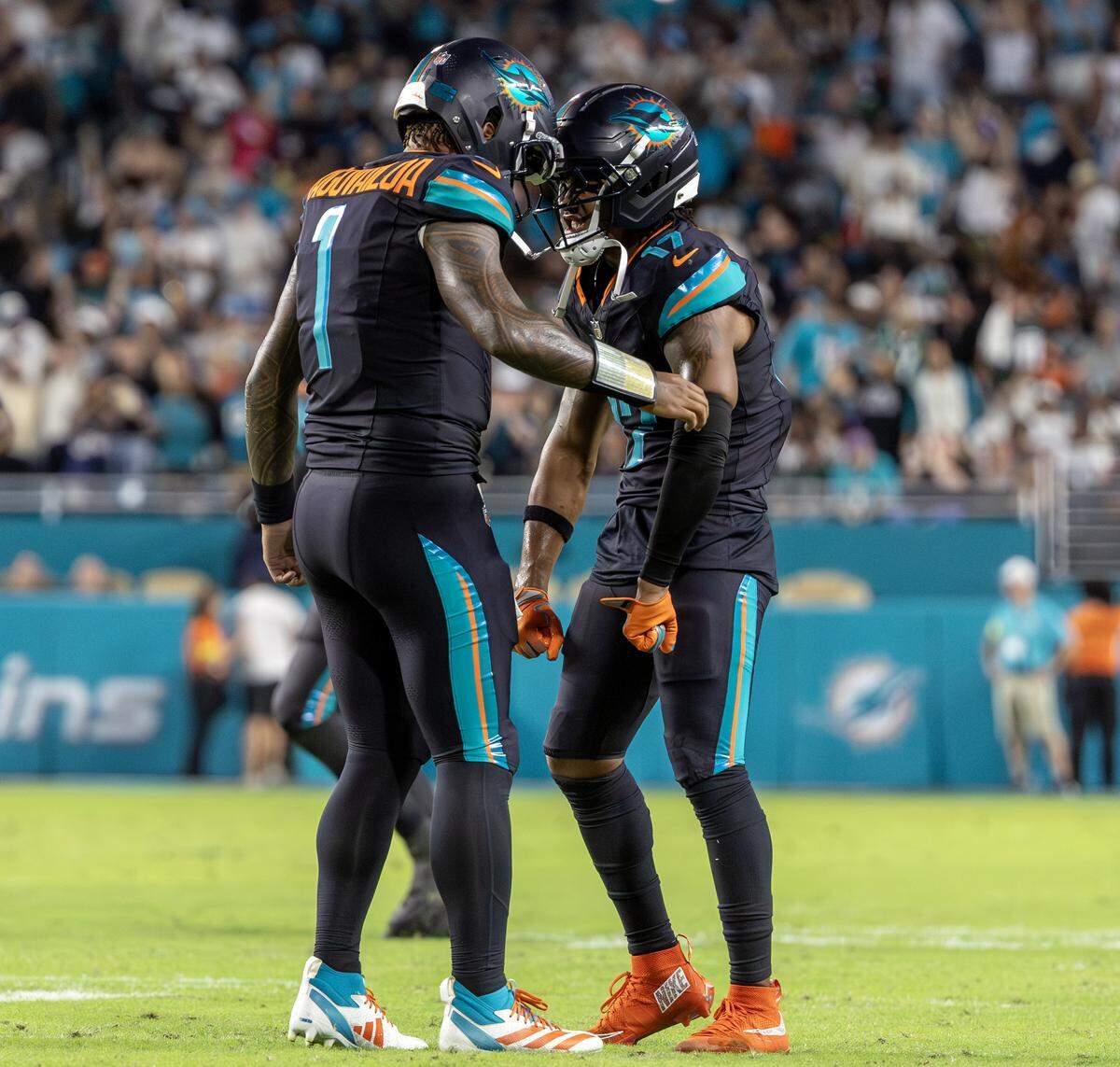 Miami Dolphins quarterback Tua Tagovailoa (1) celebrates with wide receiver Jaylen Waddle (17) after a second-half play against the New York Jets at Hard Rock Stadium on Monday, Sept. 29, 2025, in Miami Gardens, Fla.