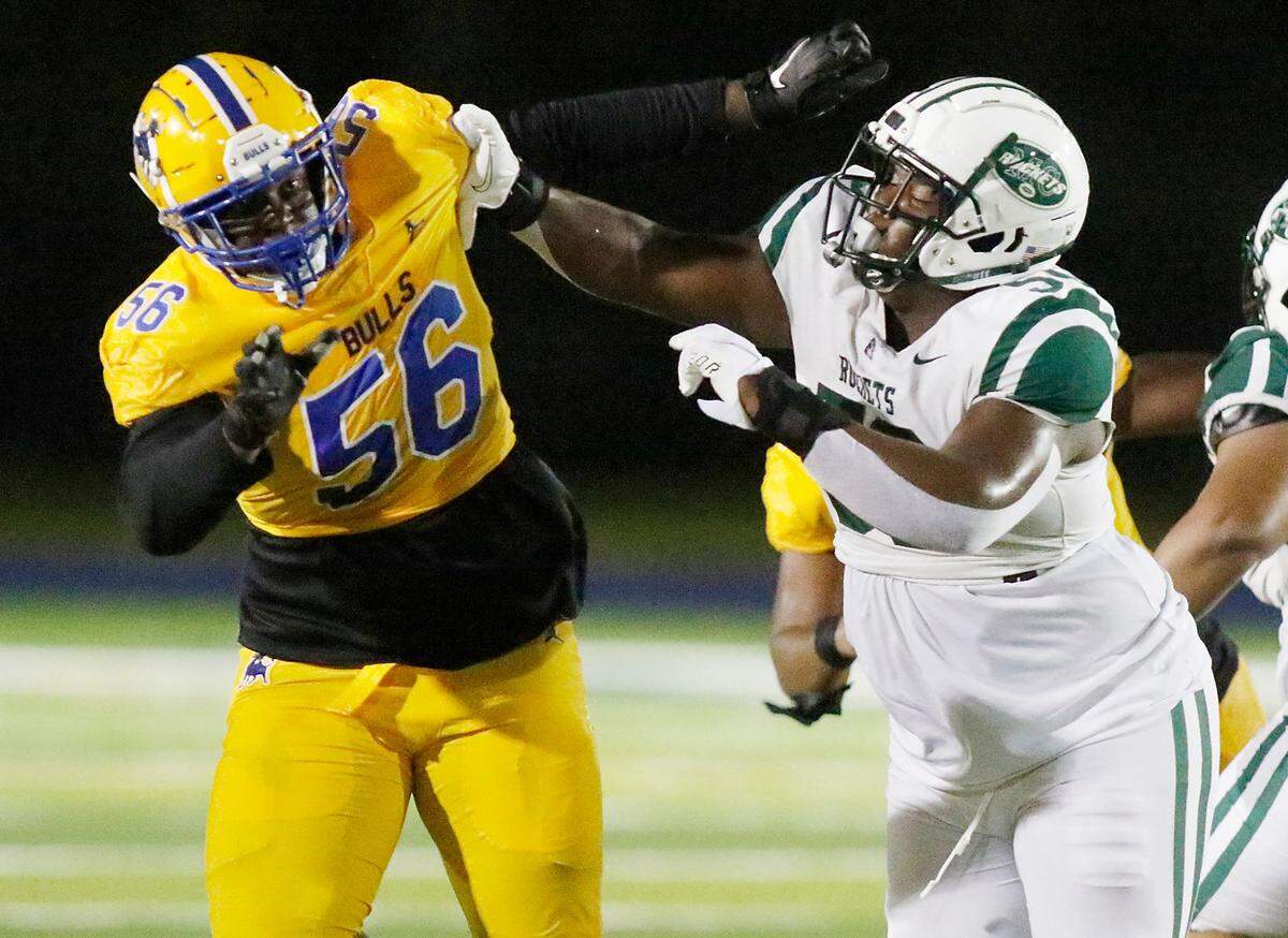 Miami Central Rockets offensive lineman Laurence Seymore (#50, on the right) plays against Northwestern Bulls during the Miami high school football season opener Friday, October 23, 2020 at Traz Powell stadium in Miami