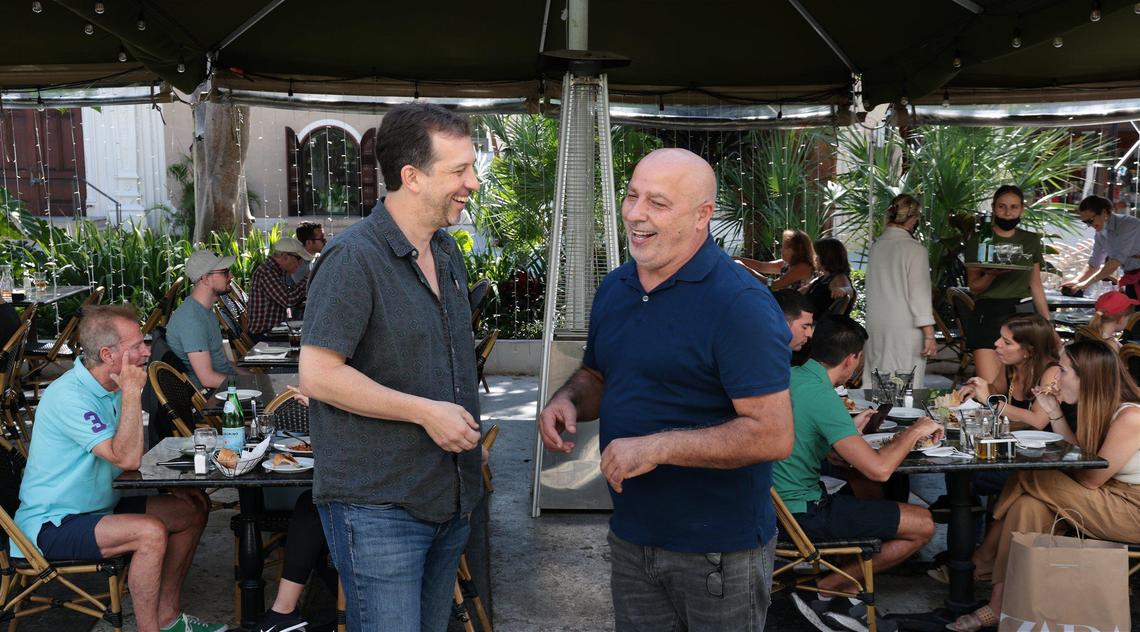 General manger Peter Saliamonas, left, and Roberto Doino, co-owner of Rosinella Italian Trattoria, chat while diners lunch at the restaurant, the oldest on South Beach’s Lincoln Road Mall. Tourists are flocking again to local hotspots at levels near pre-pandemic numbers following a dip in late December and January blamed on the fast-spreading Omicron variant of Covid-19.