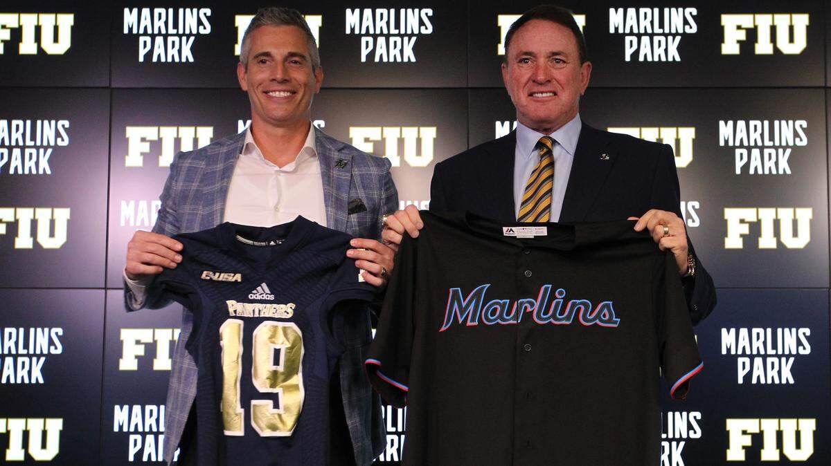 Chip Bowers, left, Miami Marlins President of Business Operations, and FIU football coach Butch Davis exchange jerseys on Jan. 16, 2019, as the Marlins announce they are hosting a November football game between the Miami Hurricanes and FIU Panthers to be played at Marlins Park. Davis gave his opinion about the transfer portal.