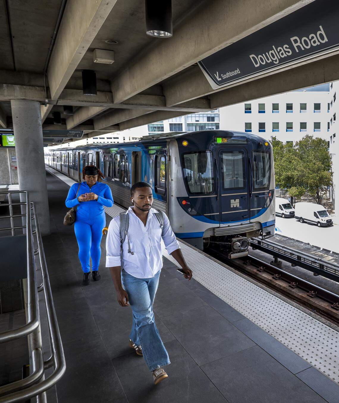 People exit the Metrorail train after it arrived to the Douglas Road station on Thursday, Aug. 7, 2025, in Miami.