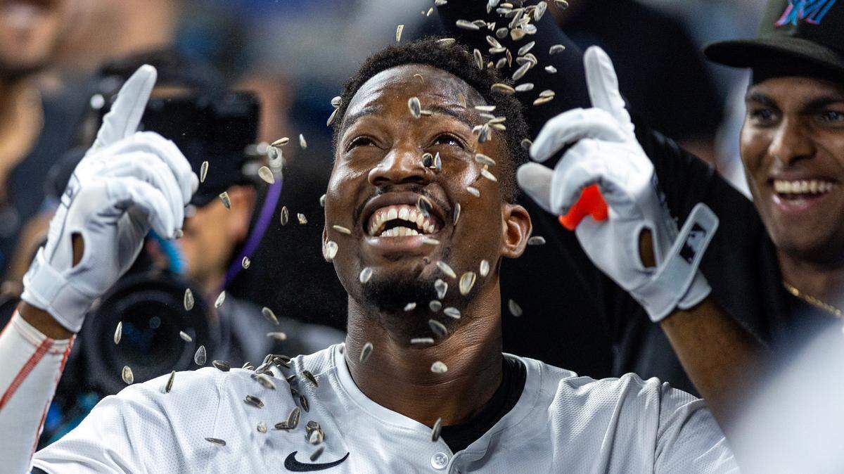 Miami Marlins right fielder Jesus Sanchez (12) reacts as teammates shower him with sunflower seeds after he hit a home run during the second inning of an MLB game against the Baltimore Orioles at loanDepot Park on Tuesday, July 23, 2024, in Miami, Fla.