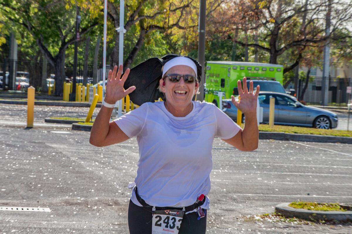 Runner Lisa Spinosa gets to the finish line of the Barry University 5K Nun Run on Saturday April 9, 2022.
