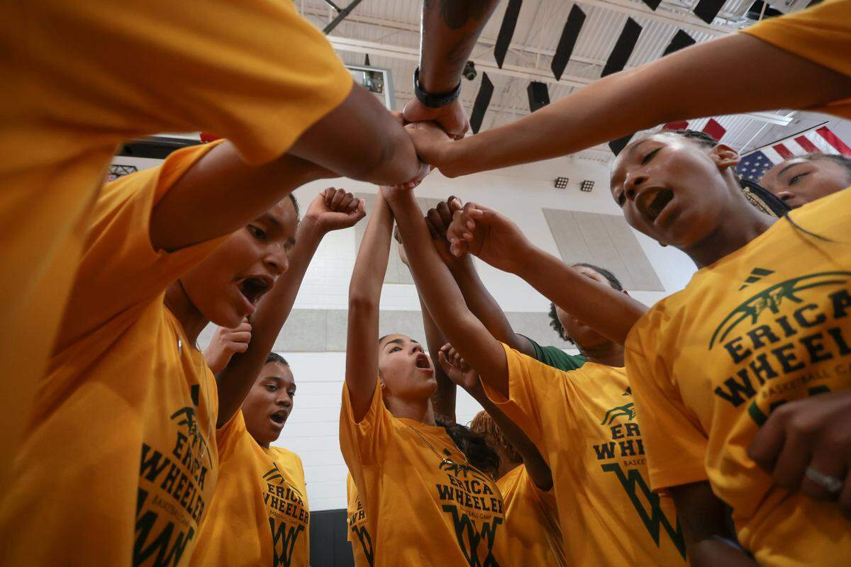 Campers celebrate after finishing a basketball drill at the Erica Wheeler Basketball Camp at Bucky Dent Park at 2240 W 60th St., in Hialeah, Florida, Saturday, October 18, 2025.