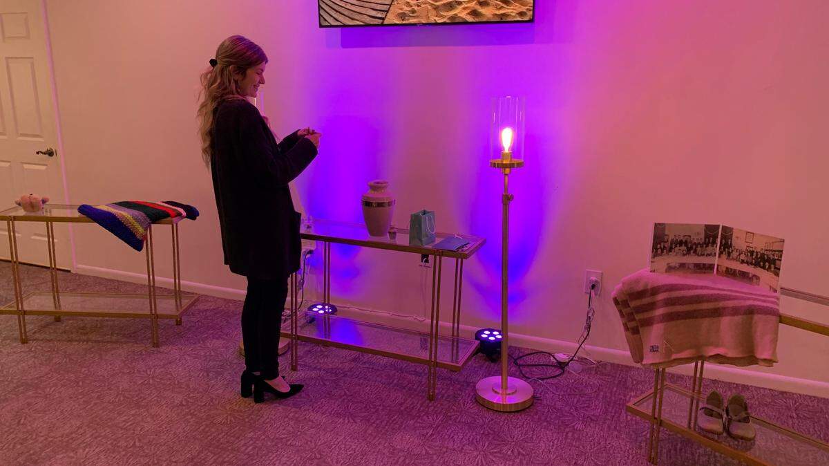 Liz Boyles, a licensed funeral director for Van Orsdel Kendall Chapel, prepares a room for a memorial service at the funeral home in September 2022. Funeral homes help facilitate the preparation of death certificates.