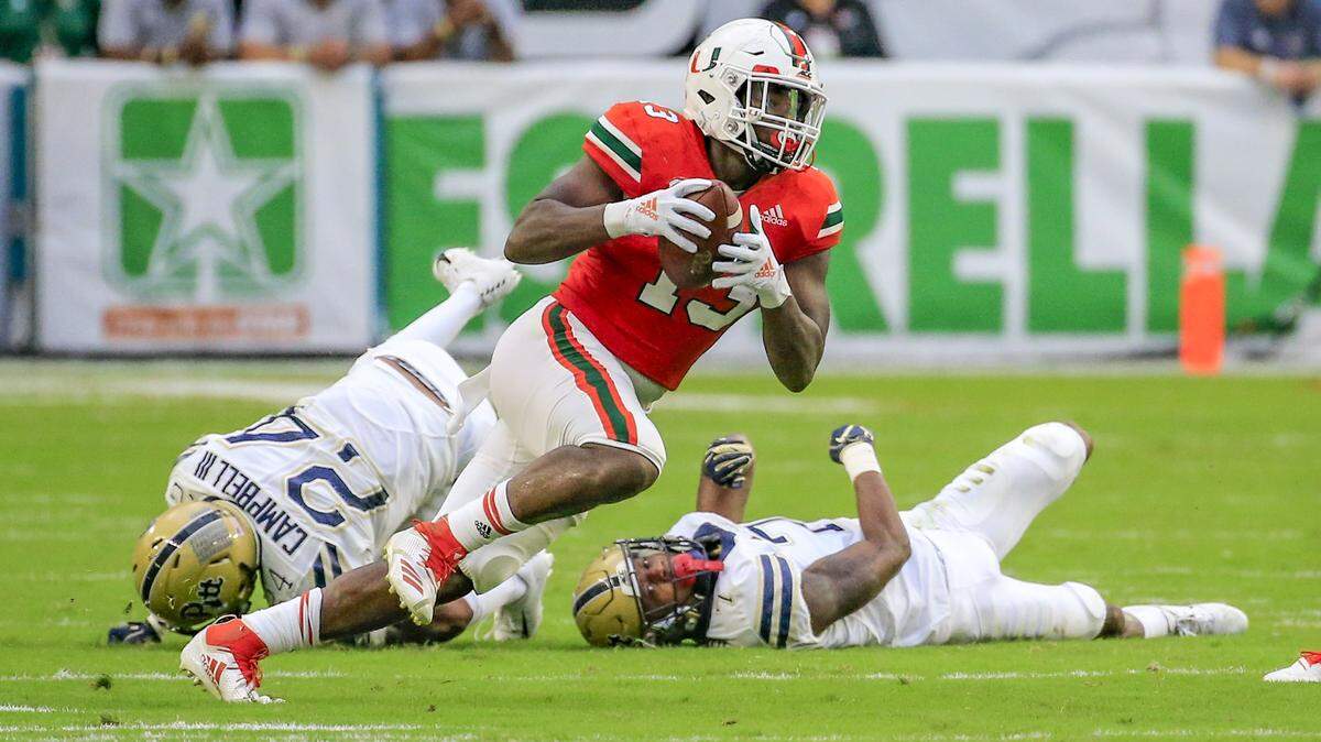 Miami Hurricanes running back DeeJay Dallas (13), seen here scoring on a punt return in UM’s Nov. 24, 2018 win against Pittsburgh, is so far holding off Cam’Ron Harris for the Canes’ starting running back job.