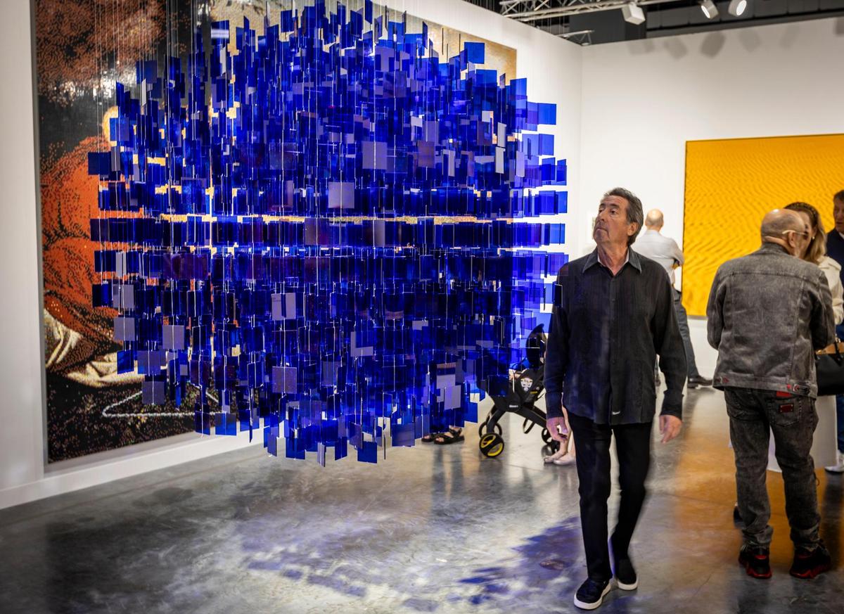 A visitor checks out Julio LeParc’s ‘Sphère Blue.’