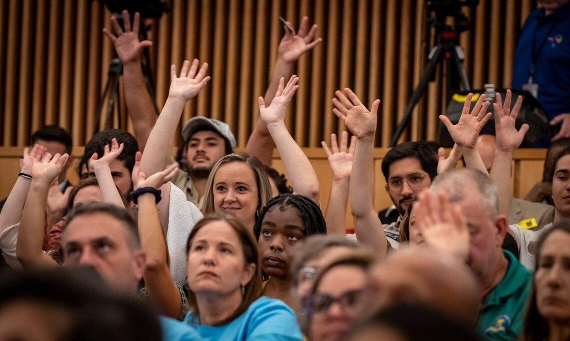 Miami, Florida, September 6, 2023 - People wave their hands in support of speakers voicing their opposition to Miami Wilds water park during the public comment portion of today’s Miami-Dade County Commission meeting. Miami-Dade commissioners will decide whether Miami Wilds water park, the for-profit project outside Zoo Miami can go forward. Environmental groups say it will destroy habitat for endangered bats and other species. Developers call it a boost to the zoo that won’t harm nature.