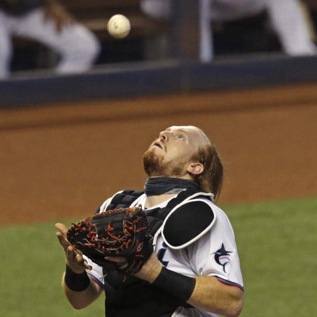 Miami Marlins catcher Chad Wallach (17) makes a catch on a foul ball by Boston Red Sox catcher Kevin Plawecki (25) during the first inning of a baseball game at at Marlins Park in Miami on Thursday, September 17, 2020.