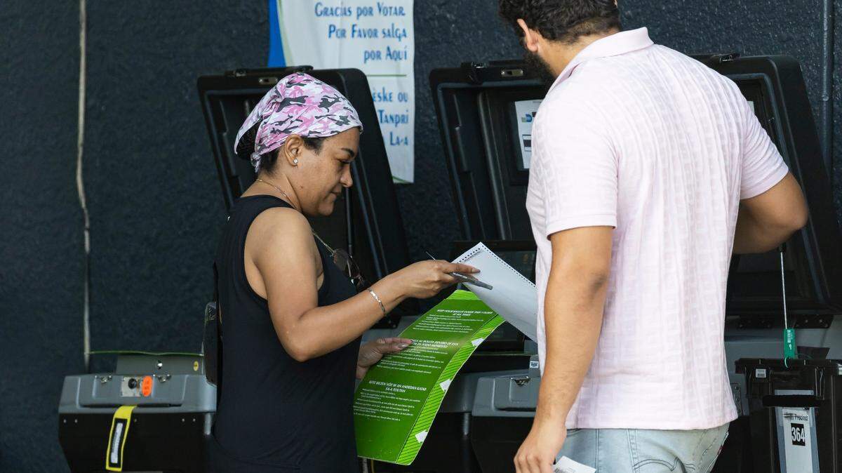 A voter turns in her ballot at the Metropolitan Dade County Palm Springs North Fire Rescue Station during Election Day on Tuesday, Aug. 20, 2024, in Miami, Fla. Items on the ticket during this election included the primaries for U.S. Senate, Miami-Dade sheriff, and the election for Miami-Dade County mayor.