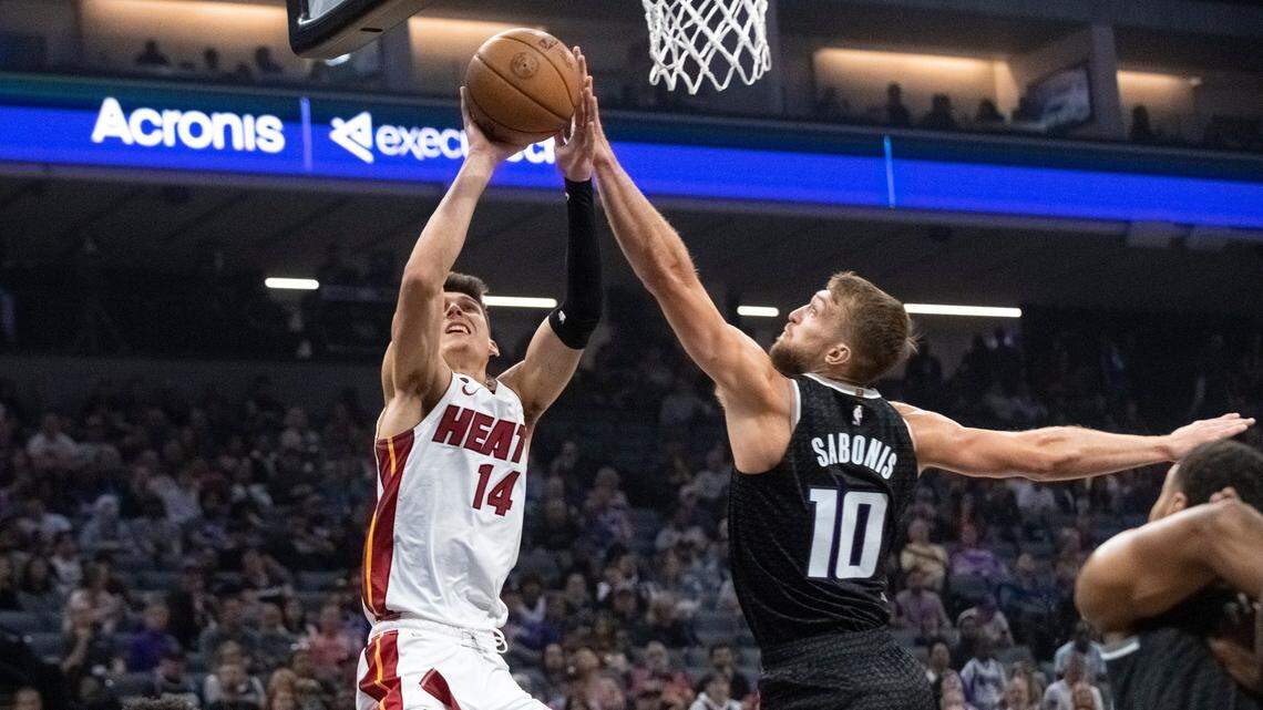 Miami Heat guard Tyler Herro (14) shoots over Sacramento Kings forward Domantas Sabonis (10) during the first quarter of an NBA basketball game in Sacramento, Calif., Saturday, Oct. 29, 2022.