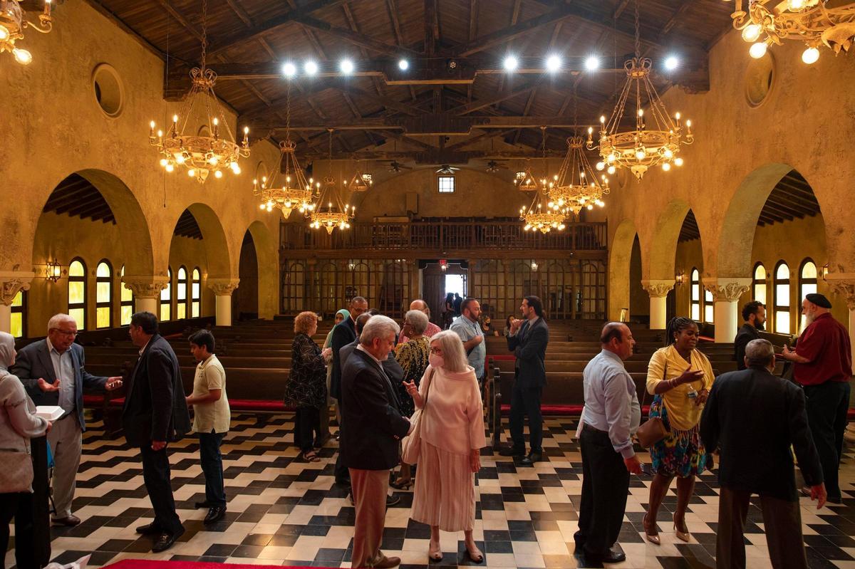 People are seen talking with each other after an interfaith discussion at Congregational United Church of Christ in Coral Gables, Florida on Sunday, July 17, 2022.