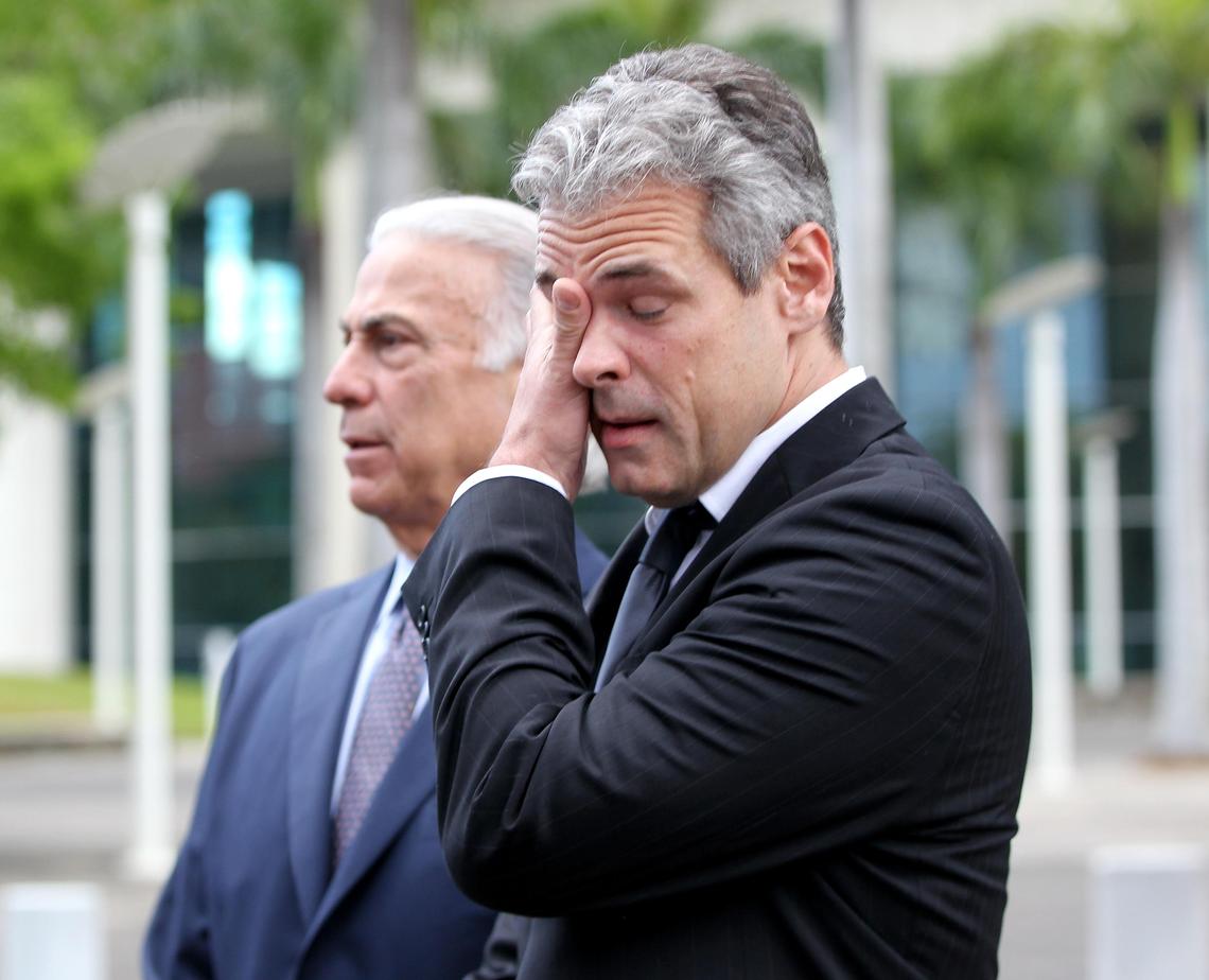 Mickael Behn reacts as he stands next to his attorney Roberto Martinez.