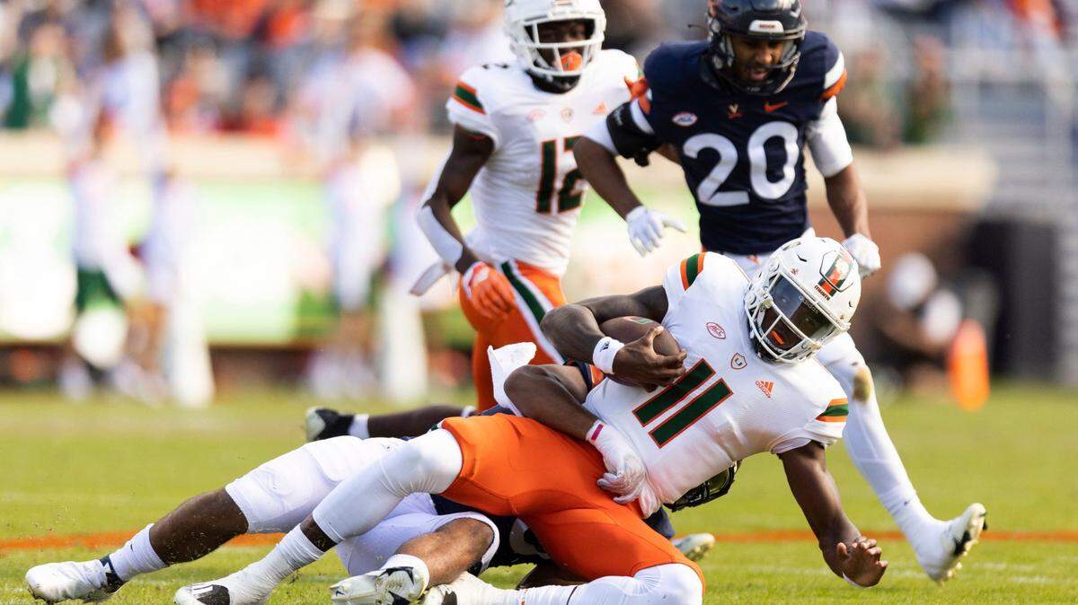 Miami quarterback Jacurri Brown is tackled during an NCAA college football game against Virginia in Charlottesville, Va., Saturday, Oct. 29, 2022. (Mike Kropf/The Daily Progress via AP)
