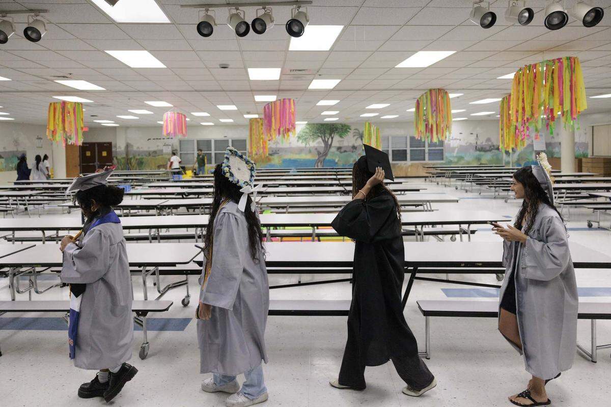 High school graduates from all over Broward walk through the cafeteria and the halls of their elementary school, Panther Run Elementary, on Monday, June 1, 2026, in Pembroke Pines, Fla.