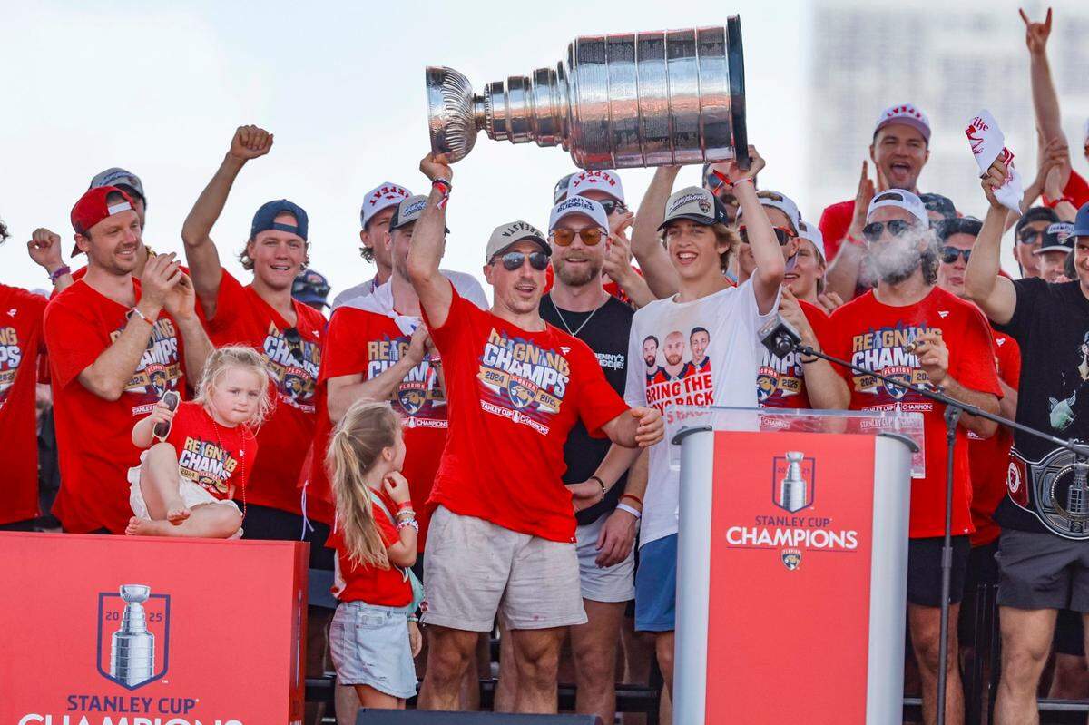 Florida Panthers center Brad Marchand celebrates with teammates and family on stage during the team’s Stanley Cup victory parade and rally along A1A in Fort Lauderdale, Florida, on Sunday, June 22, 2025.