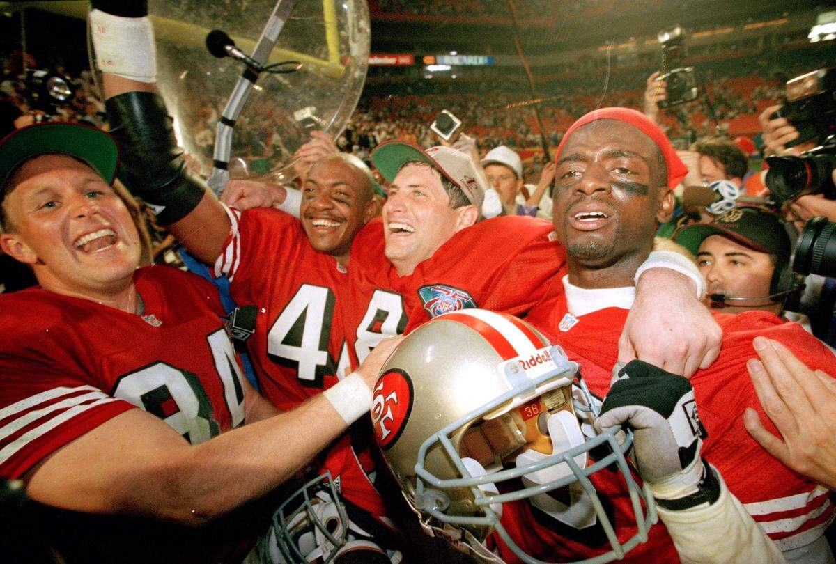 San Francisco 49ers players, from left, Brent Jones, William Floyd, Steve Young and Merton Hanks, celebrate after defeating after defeating the San Diego Chargers in Super Bowl XXIX Jan. 29, 1995 at Miami’s Joe Robbie Stadium.