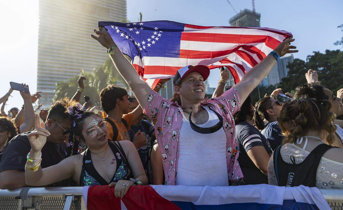 Addel Perez, from Atlanta, holds a flag as Alan Walker performs during Ultra Music Festival’s 26th anniversary at Bayfront Park on Saturday, March 28, 2026, in downtown Miami, Fla.
