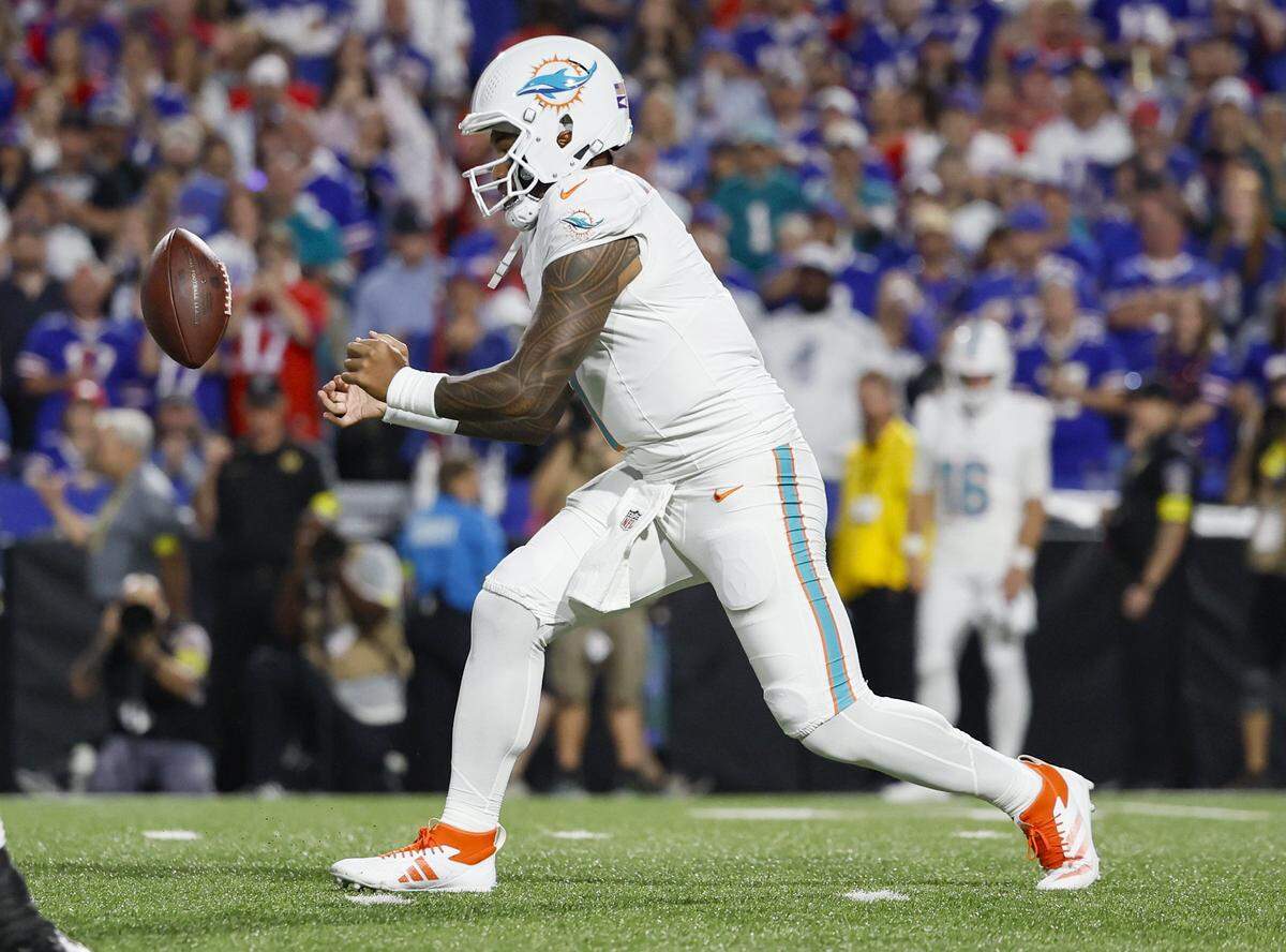 Miami Dolphins quarterback Tua Tagovailoa (1) loses the ball on a snap in the first half against the Buffalo Bills during their NFL football game at Highmark Stadium in Orchard Park, NY, on Thursday, September 18, 2025. 