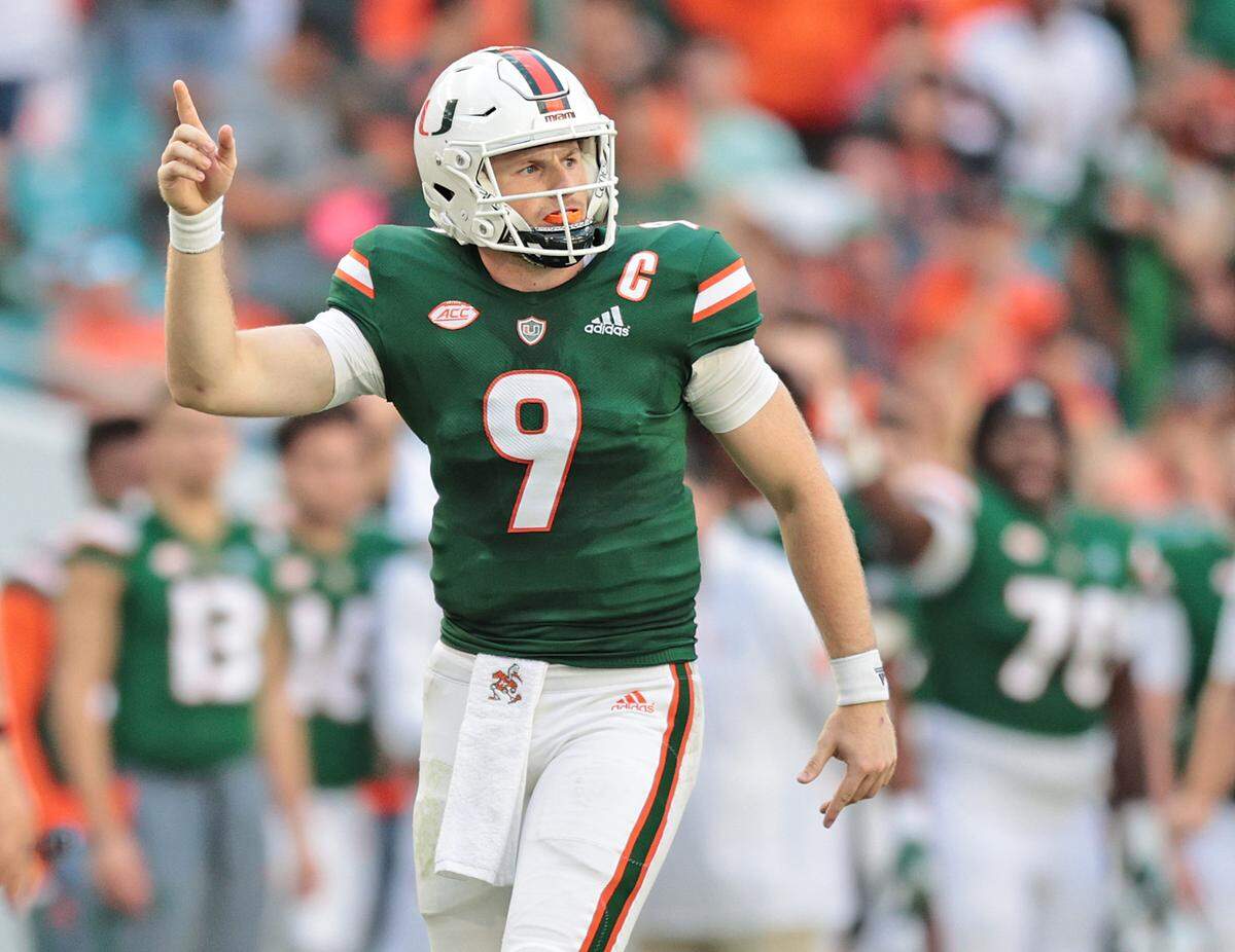 Miami Hurricanes quarterback Tyler Van Dyke (9) signals a first down by Jaylan Knighton (4) in the fourth quarter against Georgia Tech at Hard Rock Stadium in Miami Gardens on Saturday, November 6, 2021