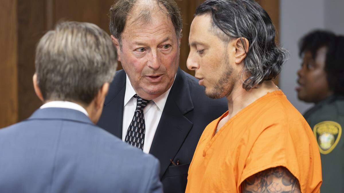 Oscar Olea, right, a former Key Biscayne gymnastics coach who allegedly sexually abused his students, talks with his attorneys Charlton Stoner, center, and Matthew Ladd, left, at the Richard E. Gerstein Justice Building on Thursday, Aug. 14, 2025, in Miami, Fla. 