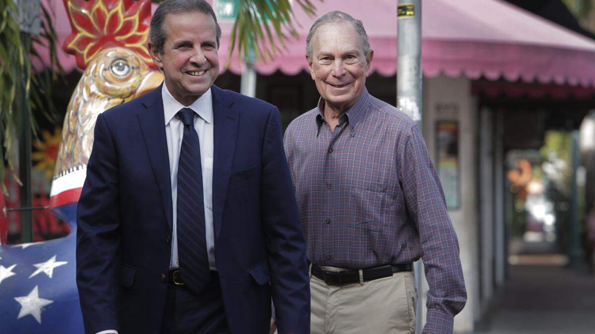 Democratic presidential candidate Mike Bloomberg walks by one of the iconic rooster statues along Calle Ocho as he campaigns in Little Havana along with former Miami Mayor Manny Diaz on March 3, 2020. Diaz is now interested in becoming chairman of the Florida Democratic Party.