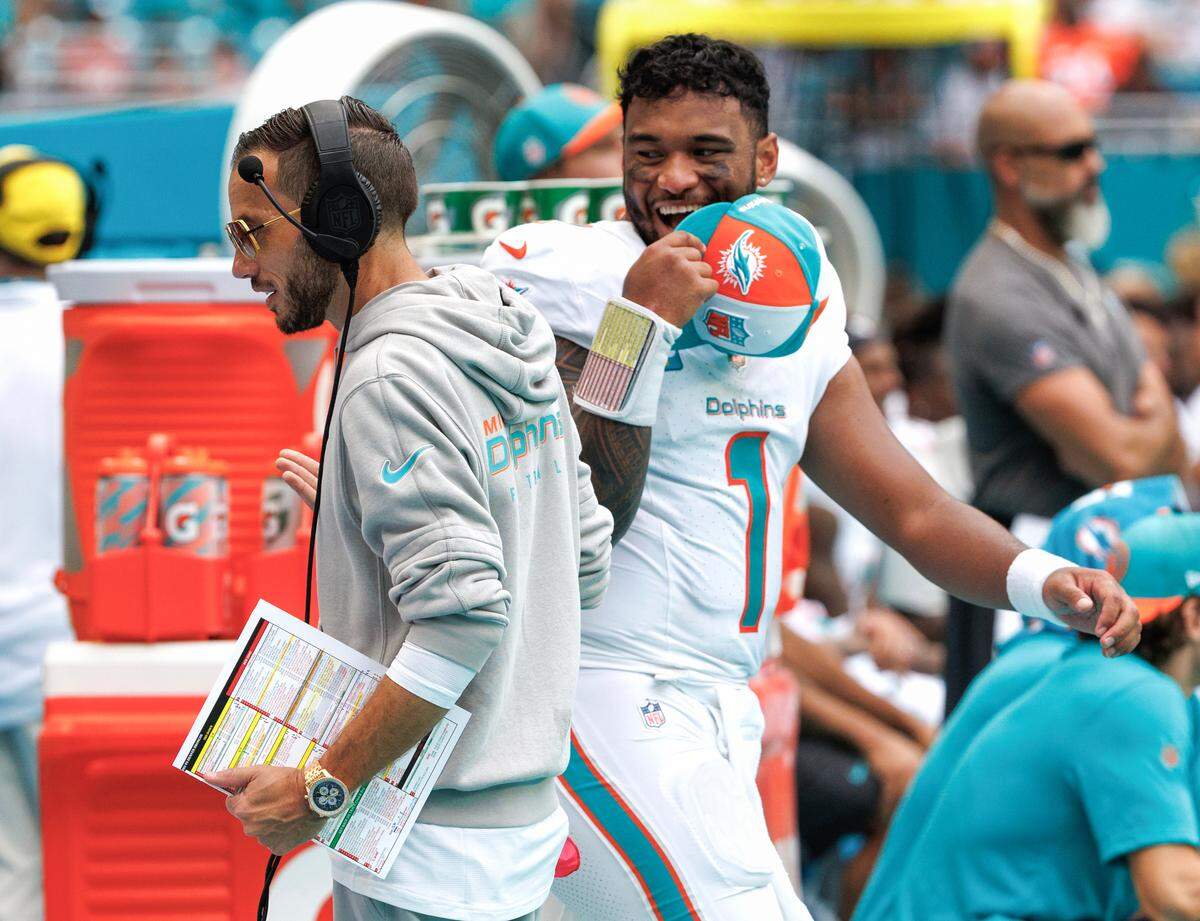 Miami Dolphins head coach Mike McDaniel talks with Dolphins quarterback Tua Tagovailoa (1) during fourth quarter of an NFL football game against the Denver Broncos at Hard Rock Stadium on Sunday, Sept. 24, 2023 in Miami Gardens, Fl.