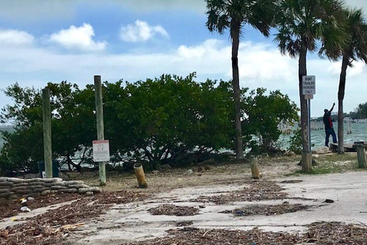 A sole fisherman occupies the public bayfront boat ramp area at Northeast 64th Street. It’s been fenced off since 2009.
