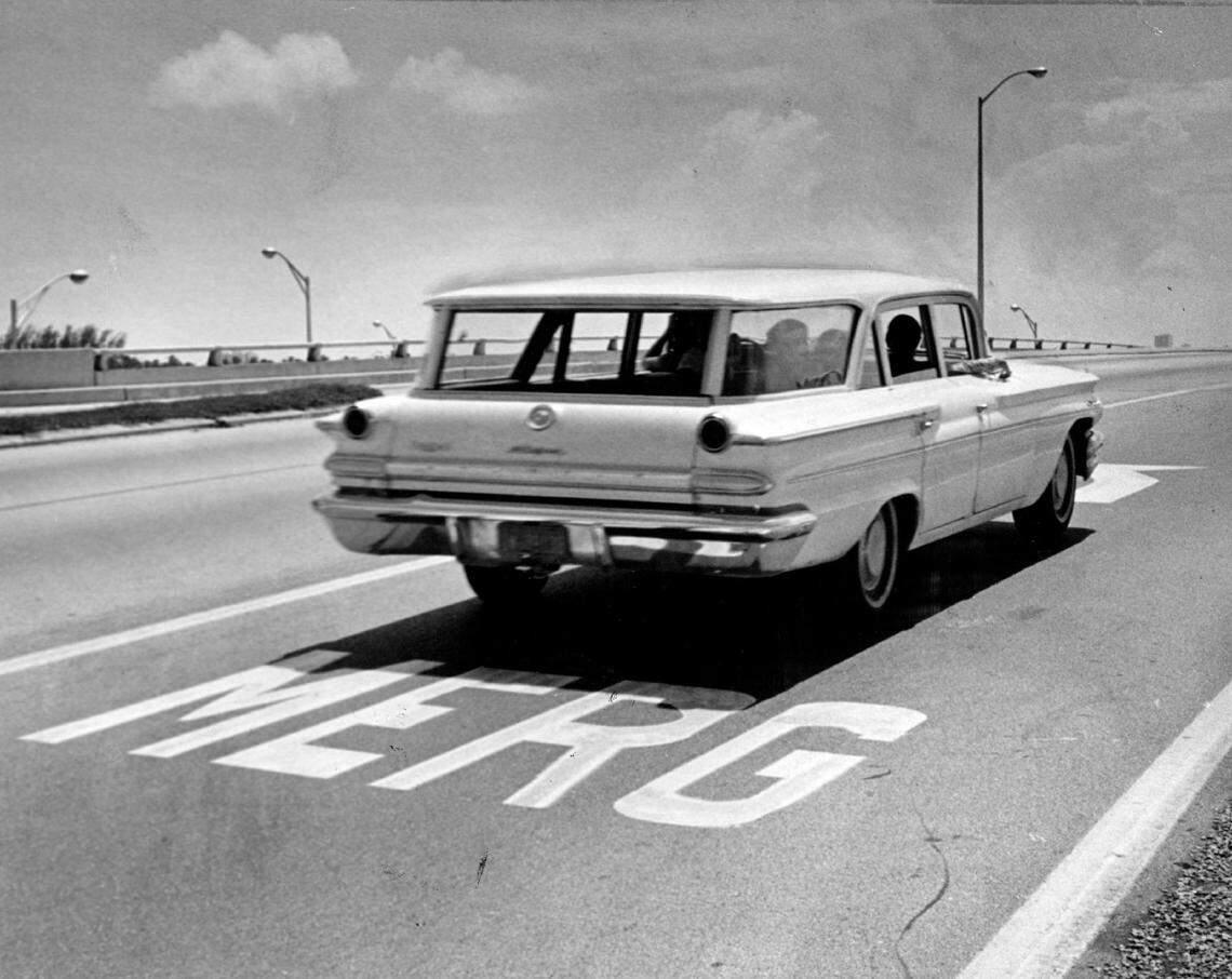 Traffic on the Miami ramp to the Julia Tuttle Causeway, with a misspelled “Merge” sign in the pavement in 1965.