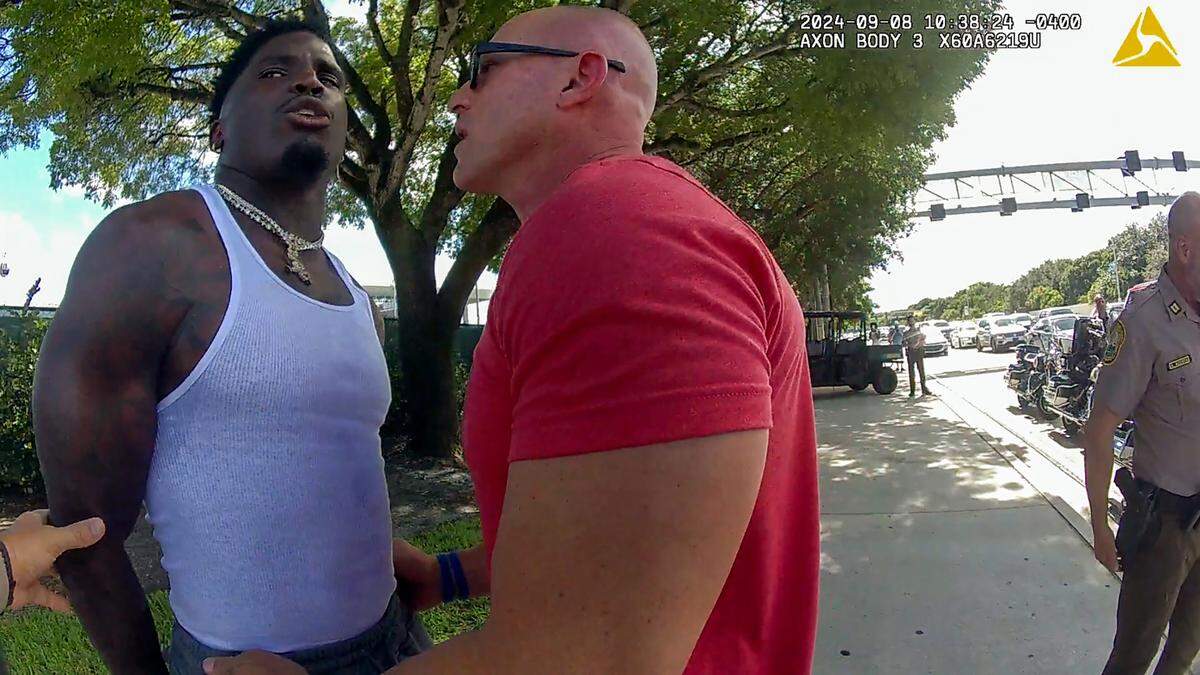 Photo captured from the Miami-Dade police body camera footage shows Drew Brooks, head of Miami Dolphins Security, talking to Tyreek Hill during Hill’s traffic stop outside Hard Rock Stadium on Sunday, Sept. 8, 2024. Hill was detained by Miami-Dade Police for speeding.