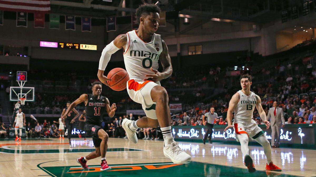 Miami Hurricanes guard Chris Lykes (0) pass the ball to teammate Anthony Mack (13) during the first half of an NCAA college basketball game against the NC State Wolfpack at the Watsco Center in Coral Gables on Thursday, January 3, 2019