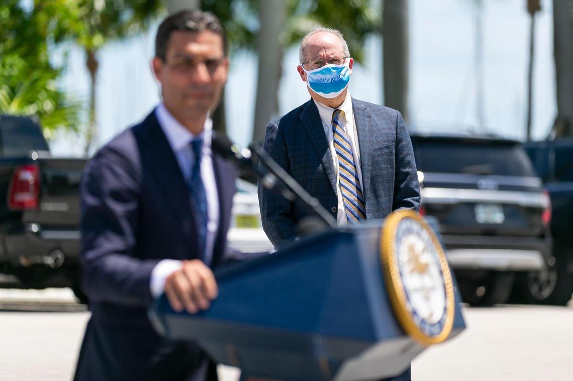 Miami Beach Mayor Dan Gelber listens as City of Miami Mayor Francis Suarez speaks during a COVID-19 press conference outside of Miami City Hall in Coconut Grove, Florida on Monday, June 22, 2020. A total of 15 Miami-Dade mayors gathered to announce stricter enforcement of COVID-19 rules across the county.