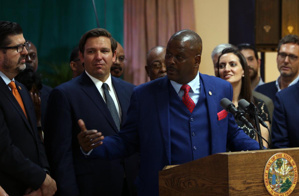 Rep. James Bush speaks alongside Gov. Ron DeSantis during the bill signing ceremony at William A. Kirlew Junior Academy, a Seventh-day Adventist K-8 school in Miami Gardens, on Thursday, May 9, 2019.