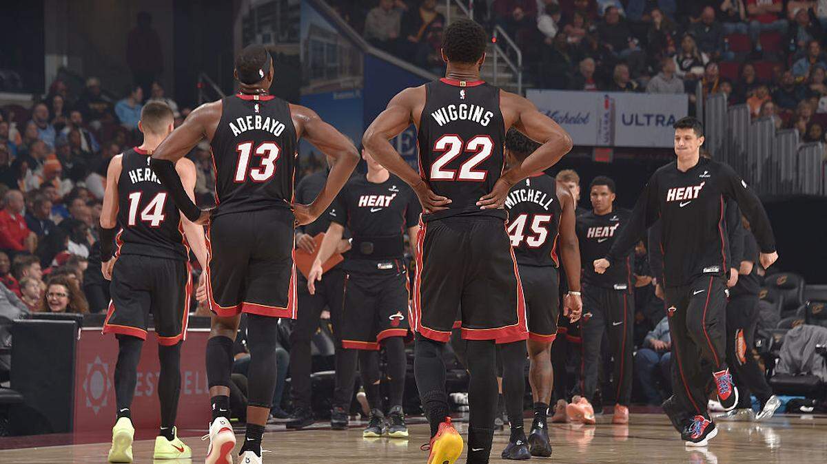 Andrew Wiggins #22, Bam Adebayo #13, Tyler Herro #14, Davion Mitchell #45, and Simone Fontecchio #0 of the Miami Heat look on during the game against the Cleveland Cavaliers on March 25, 2026 at Rocket Arena in Cleveland.