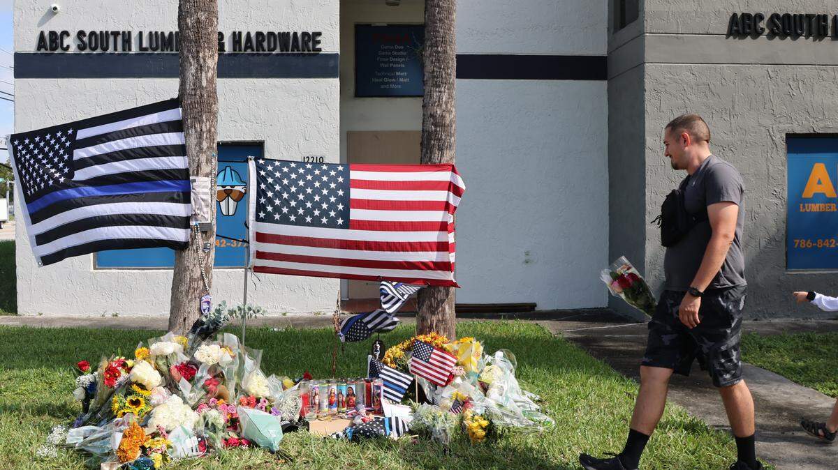 A memorial for fallen Deputy Devin Jaramillo continues to grow as mourners gather with candles, flags, flowers, rosaries, prayers and other token of remembrance on Monday, November 10, 2025 in Southwest Miami-Dade, Florida. 