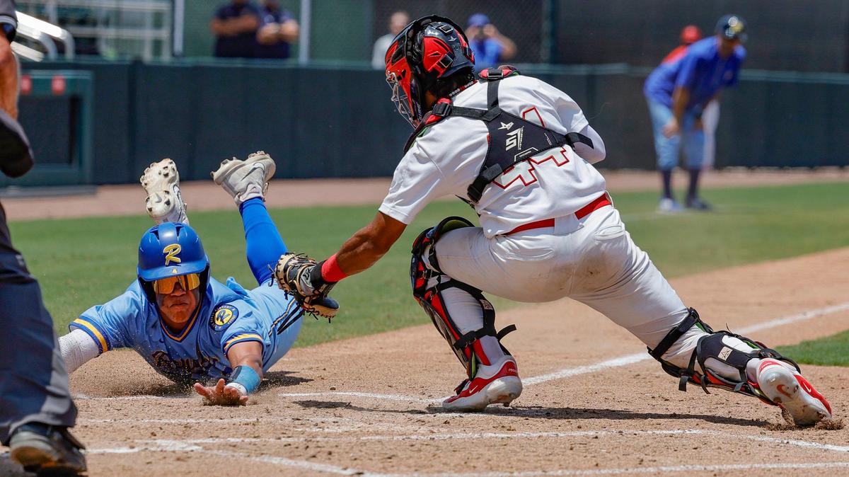 Miami Christian Victors catcher Rafael Sosa (44) tags out Orlando First Academy Royals Blake Fields (4) in the second inning of the FHSAA Class 2A state baseball semifinal at Hammond Stadium in Fort Myers, Florida on Monday, May 20, 2024.